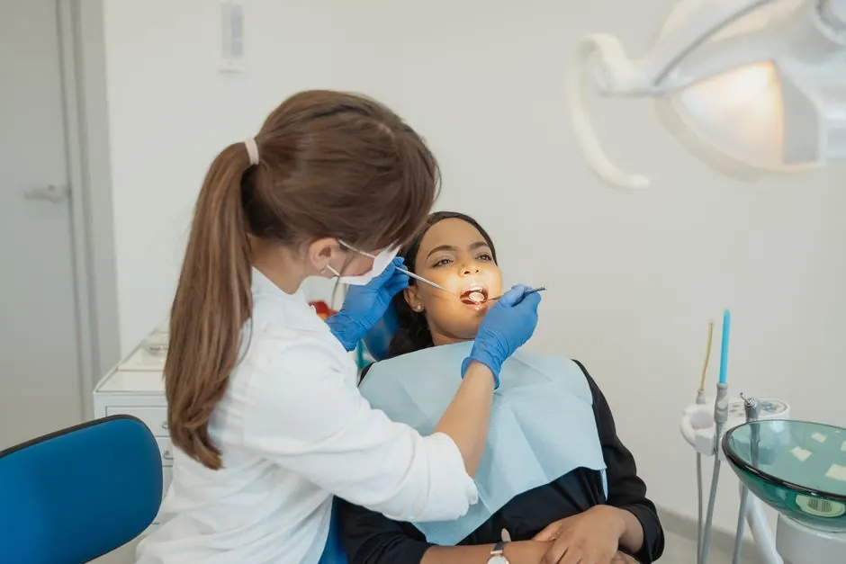 Dentist conducting a dental examination on a patient in a modern clinic setting.